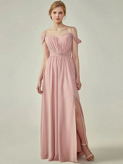 Woman wearing a light blue A-line chiffon bridesmaid dress with spaghetti straps, V-neck, ruching, and a side slit.
