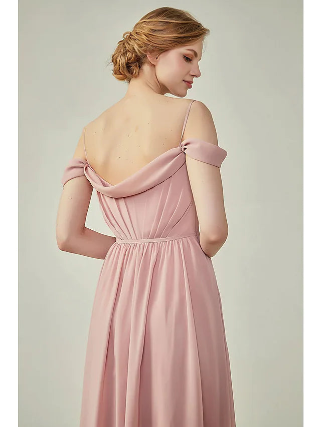Side view of a woman in a light blue A-line chiffon dress, showcasing the floor-length skirt and high slit.