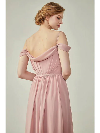 Side view of a woman in a light blue A-line chiffon dress, showcasing the floor-length skirt and high slit.