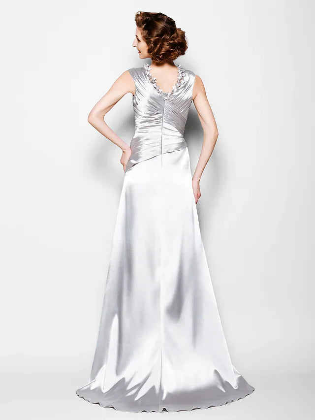 Close-up of the V-neckline and criss-cross beading on the elegant satin dress.