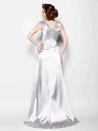 Close-up of the V-neckline and criss-cross beading on the elegant satin dress.