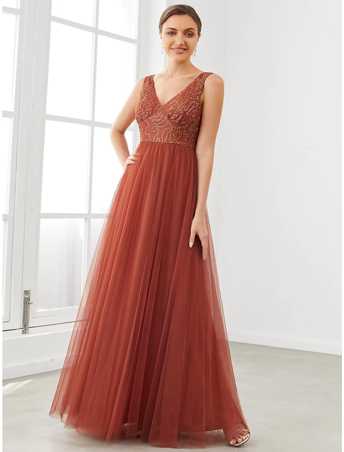 Close-up of the V-neckline and delicate tulle fabric of the prom dress.