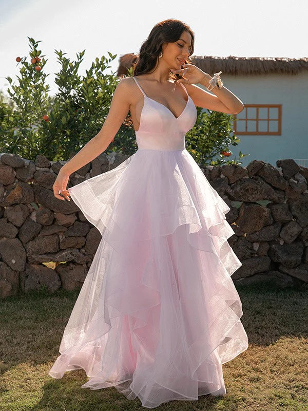 Woman in a pink A-line V-neck tulle ruffle floor-length prom dress.