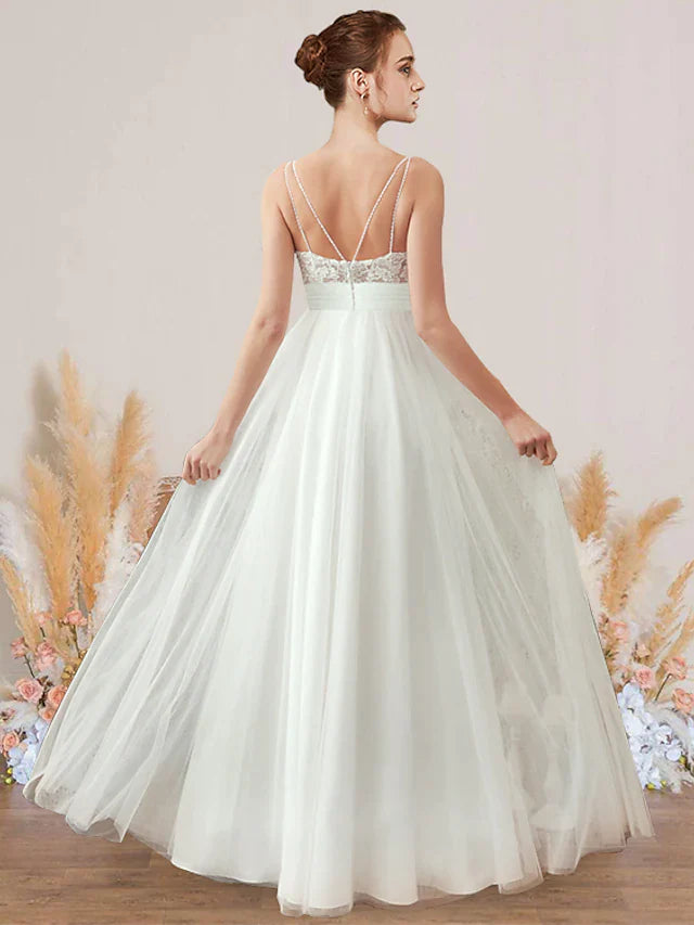 Back view of A-Line V-neck wedding dress with spaghetti straps, lace details, and floor-length train.