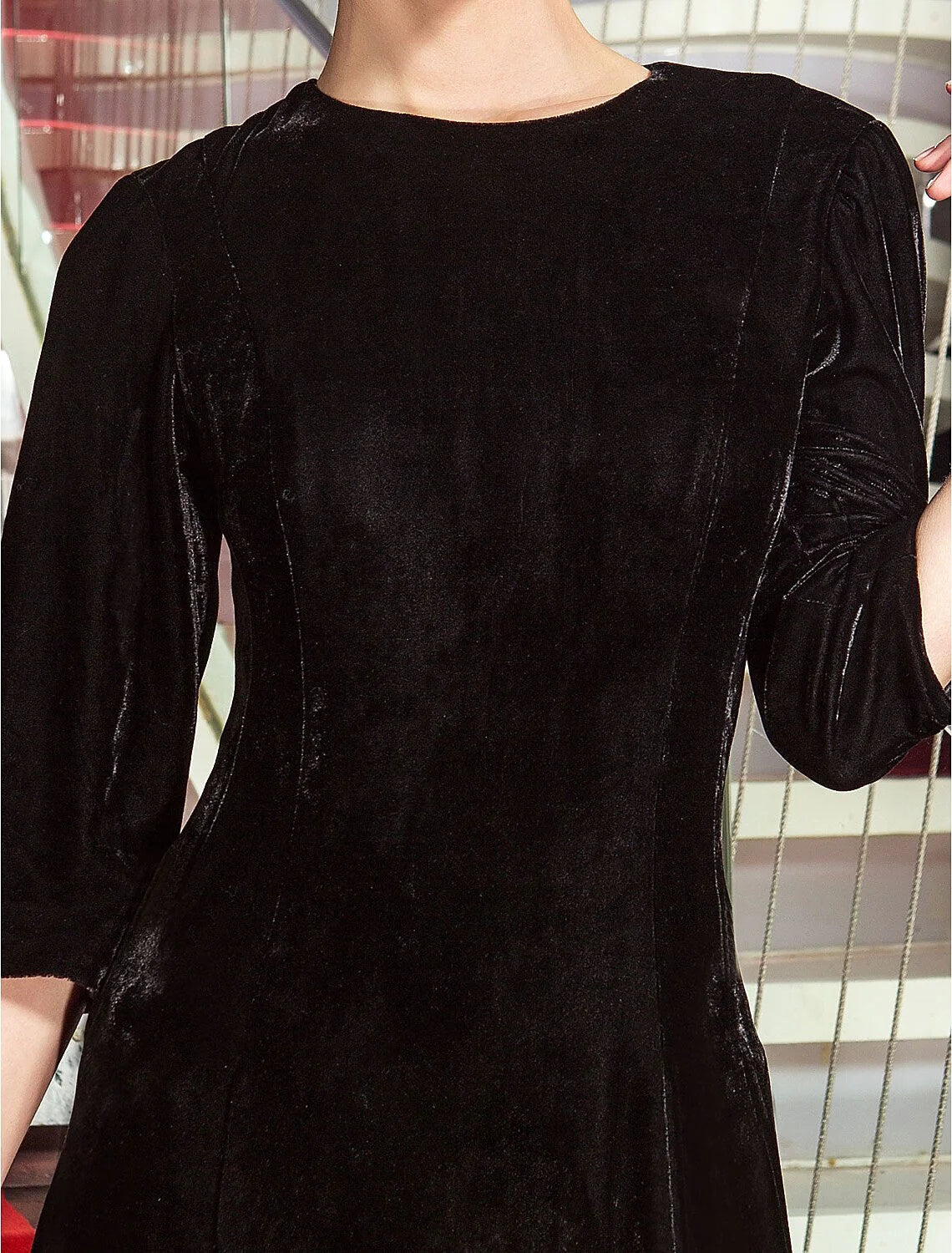 Side profile of the A-line velvet dress, highlighting the 3/4 sleeves and silhouette.