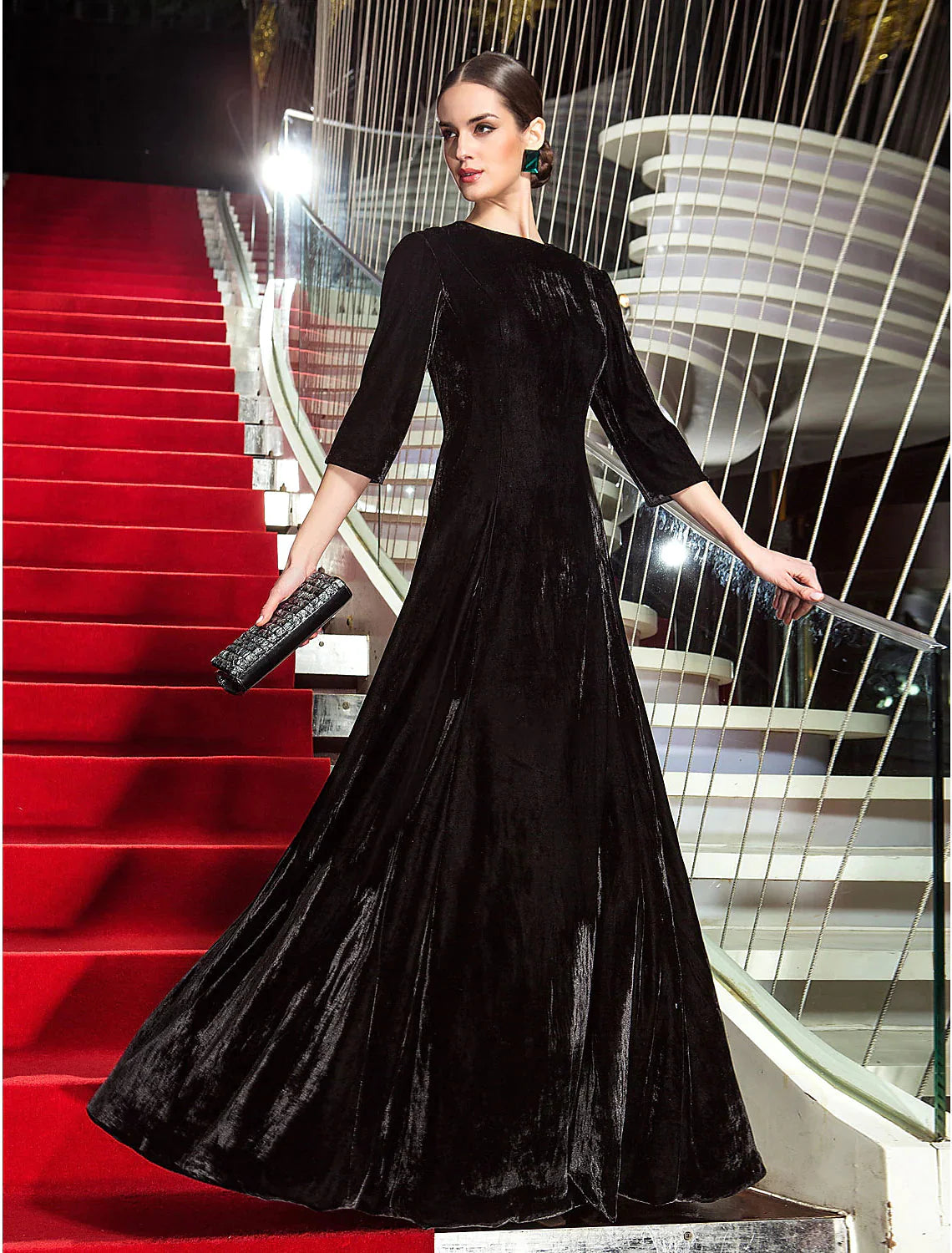 Model posing in the A-line velvet dress, showcasing its flow and pleated details.