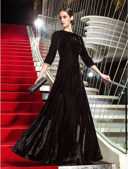 Model posing in the A-line velvet dress, showcasing its flow and pleated details.