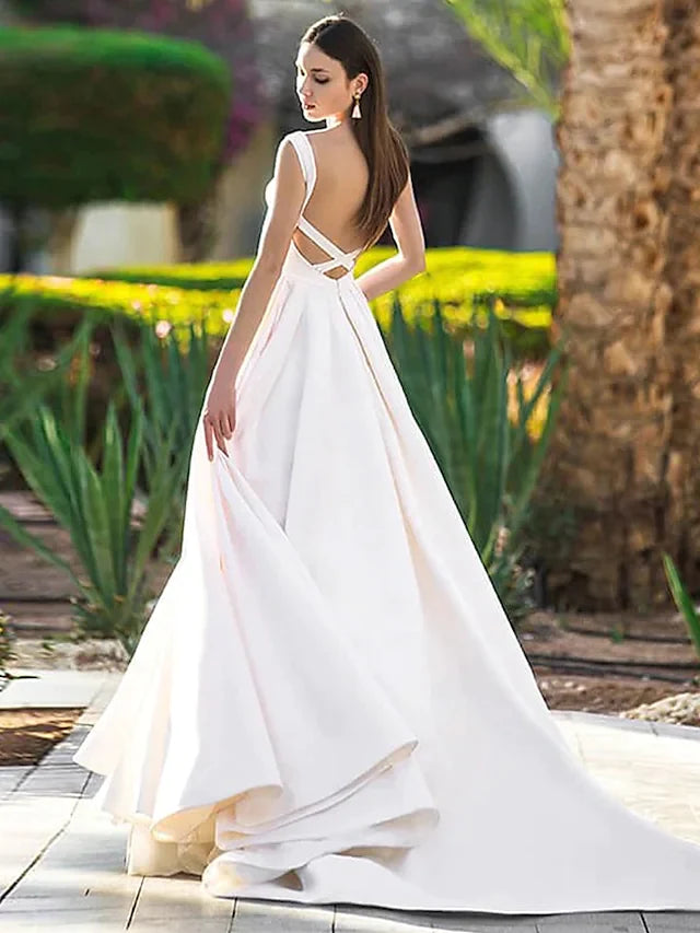 Close-up of the bateau neckline and cap sleeves on the white A-Line wedding dress.