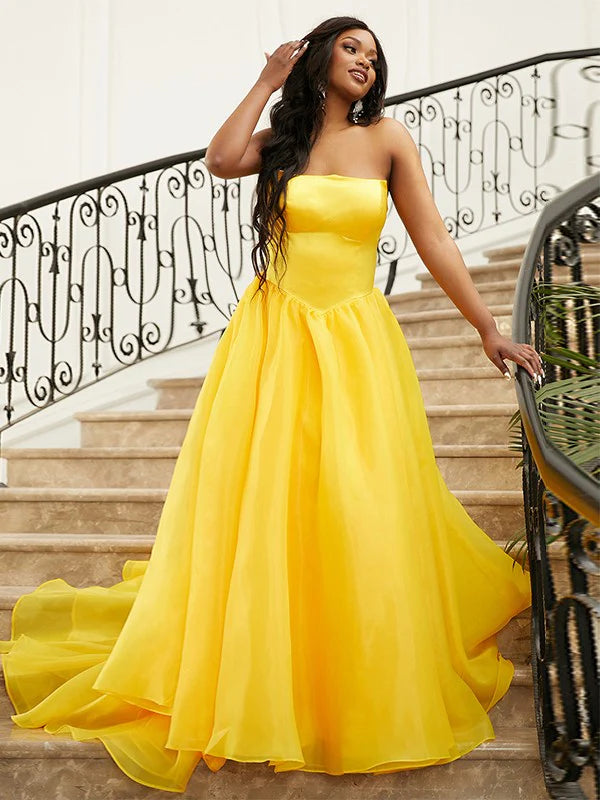 Side view of an aqua blue A-line satin prom dress, showing the flowing skirt and strapless design.