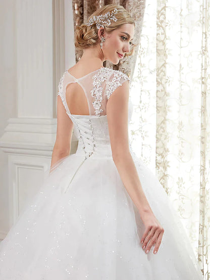 Side view of a lace and tulle ball gown wedding dress with beading.