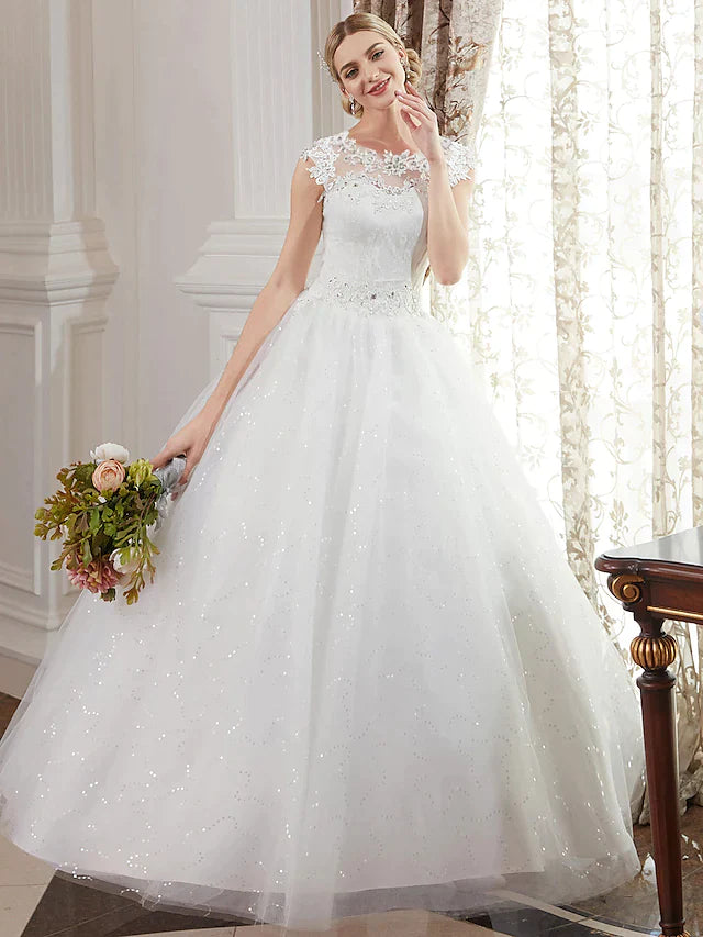 Close-up of the jewel neck and intricate beaded lace on the wedding gown.
