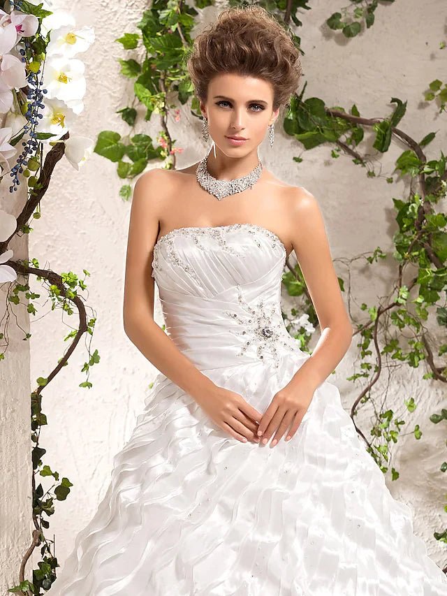 Side profile of a bride in an elegant strapless wedding dress.