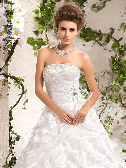 Side profile of a bride in an elegant strapless wedding dress.