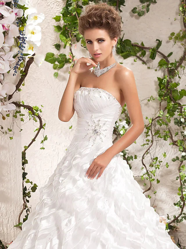 Detailed view of the taffeta fabric and ruffle design on the wedding dress.