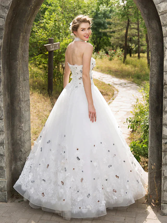 Close-up of the sweetheart neckline and intricate lace details on the wedding dress.