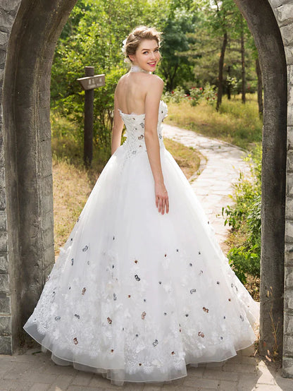 Close-up of the sweetheart neckline and intricate lace details on the wedding dress.