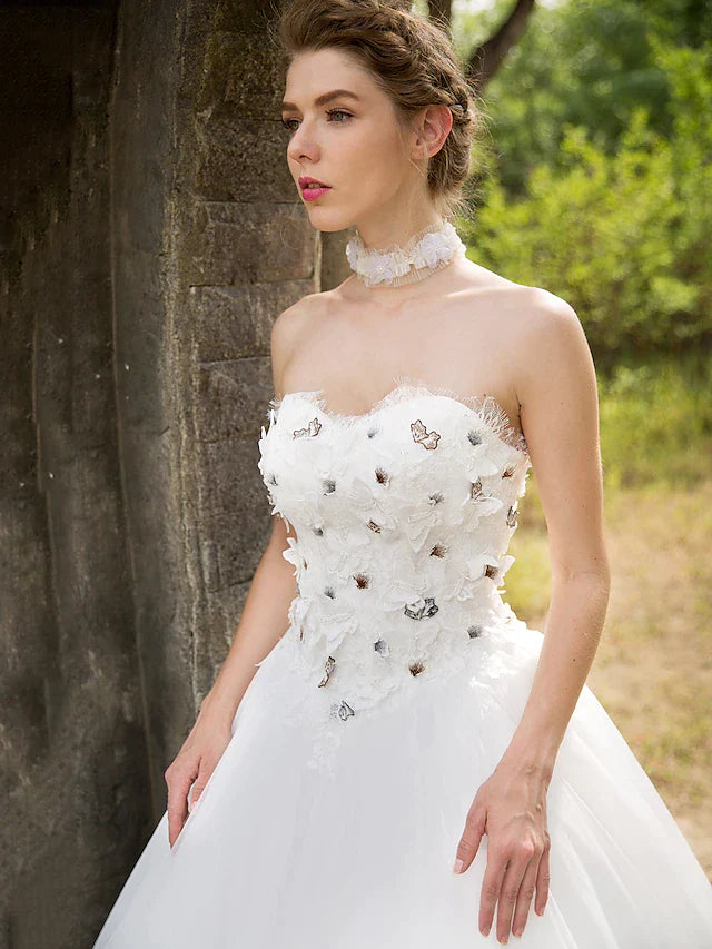 Back view of the floor-length ball gown wedding dress, showcasing the tulle skirt.