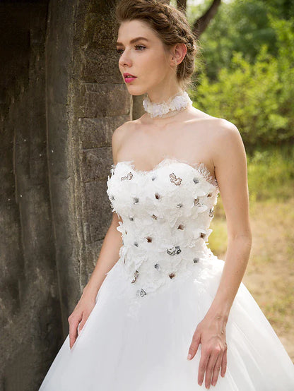 Back view of the floor-length ball gown wedding dress, showcasing the tulle skirt.