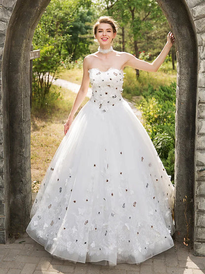 Detail of the floral lace appliques on the bodice of the bridal gown.
