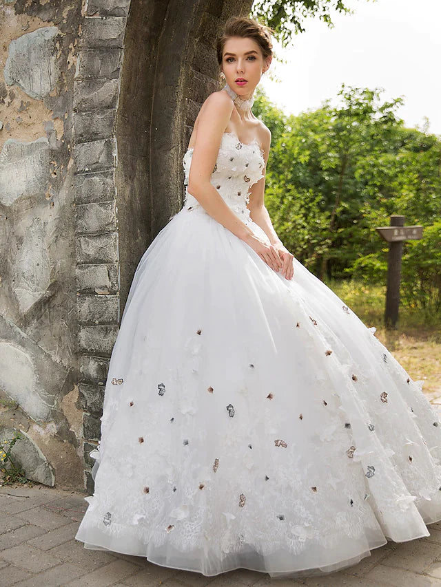Close-up of the flowing tulle skirt and lace hem of the wedding dress.