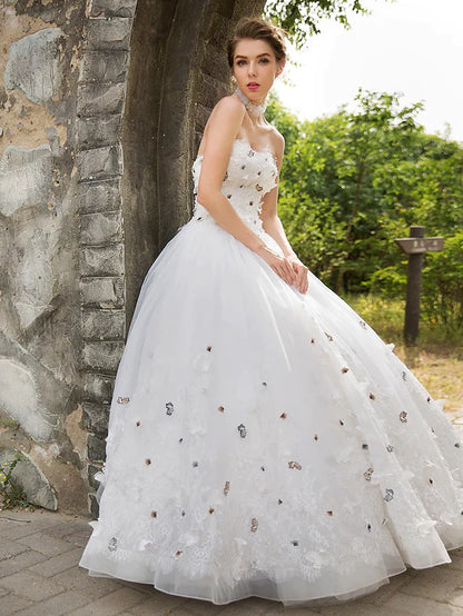 Close-up of the flowing tulle skirt and lace hem of the wedding dress.