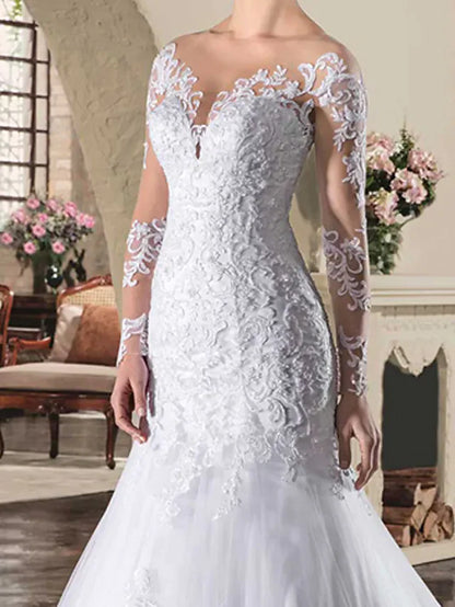 Back view of the wedding dress showing see-through lace and appliques.