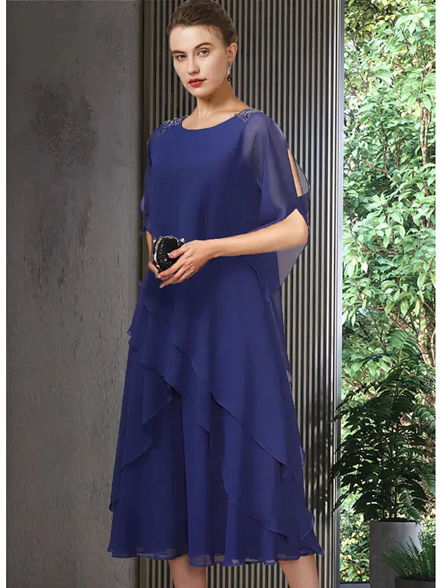 Elegant blue A-line chiffon Mother of the Bride dress with jewel neck, half sleeves, and tea length ruffles.