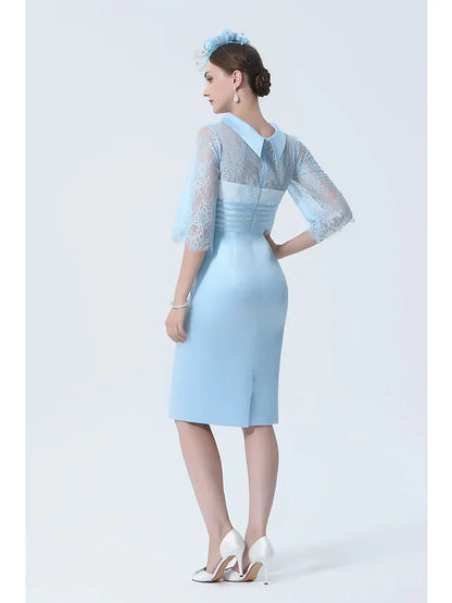 Side view of a woman in a sophisticated charmeuse Mother of the Bride dress with a lace sash ribbon.