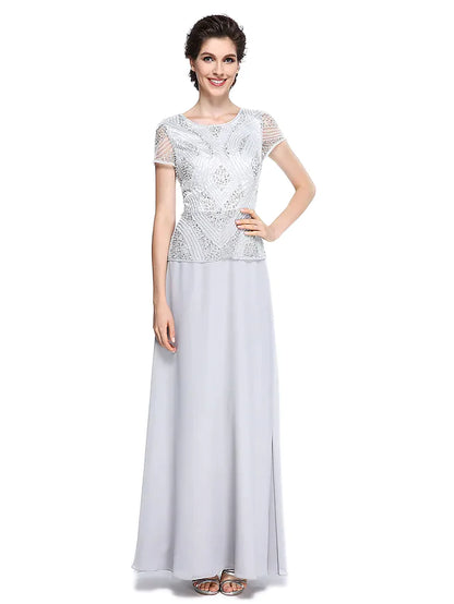 Woman wearing an elegant jewel neck, short sleeve, floor-length chiffon mother of the bride dress with beading and sequins.