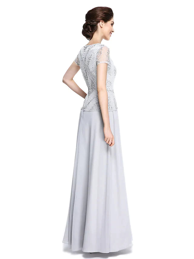 Side view of the woman in the elegant chiffon mother of the bride dress, highlighting the short sleeves.