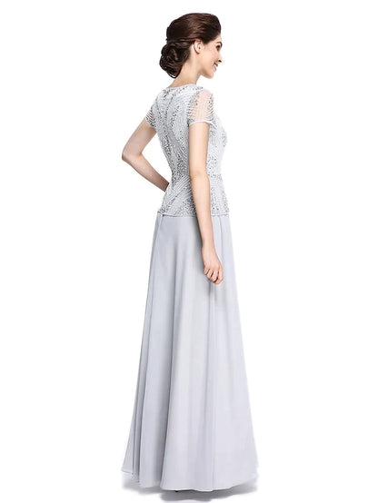 Side view of the woman in the elegant chiffon mother of the bride dress, highlighting the short sleeves.