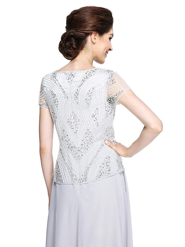 Full length view of the woman posing in the beaded and sequined chiffon gown.