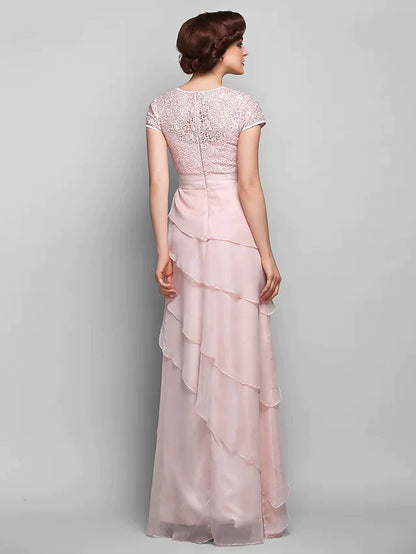 Side view of the elegant chiffon and lace gown, highlighting the short sleeves and flowing floor-length skirt.