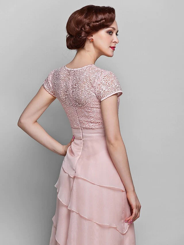 Close-up of the jewel neck and intricate lace bodice of the short sleeve Mother of the Bride dress.
