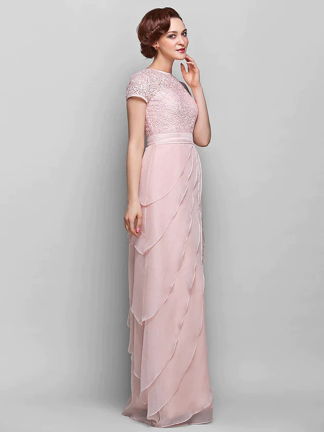 Model posing gracefully in the floor-length Mother of the Bride dress, showing its full silhouette.