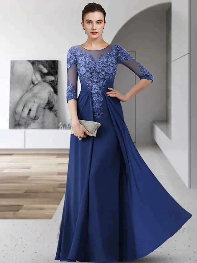 A woman wearing an elegant floor-length Mother of the Bride dress with a jewel neck, 3/4 lace sleeves, and ruched chiffon.