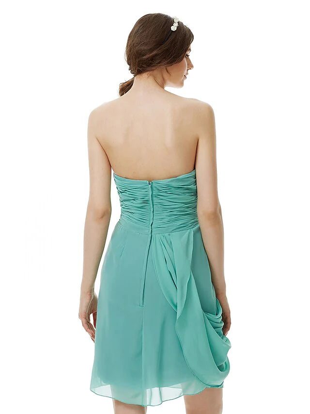 Side view of the light pink strapless knee-length chiffon bridesmaid dress, highlighting the draping.