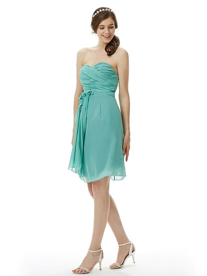 Woman walking in the light pink strapless knee-length chiffon bridesmaid dress, demonstrating movement.