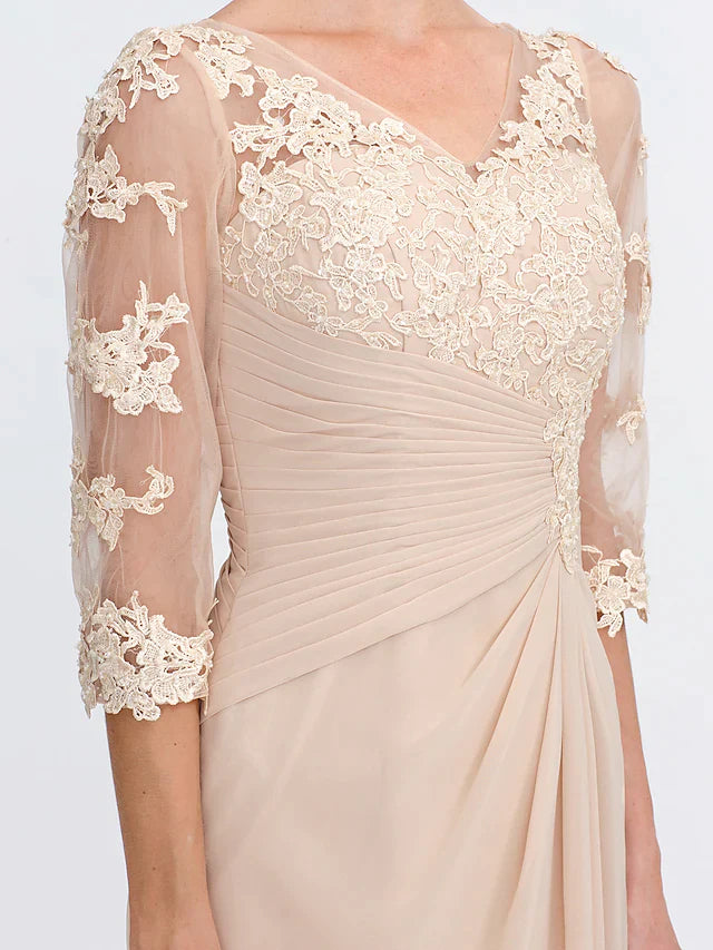 Close-up of the sheer lace half sleeve and delicate appliques on the dark blue dress.