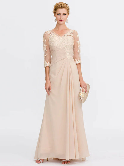 Model posing in a dark blue Mother of the Bride dress, showing the elegant V-neckline.
