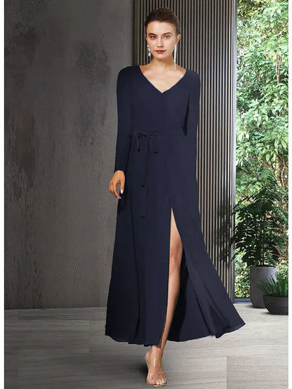 Woman wearing an elegant V-neck long sleeve chiffon Mother of the Bride dress with bow detail and split front.