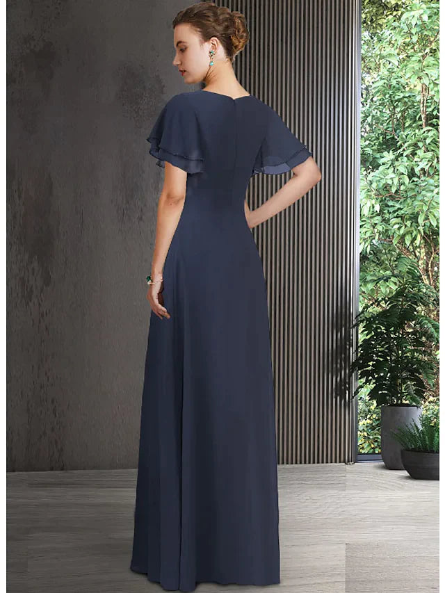 Close-up of appliques and ruching detail on a V-neck chiffon dress.