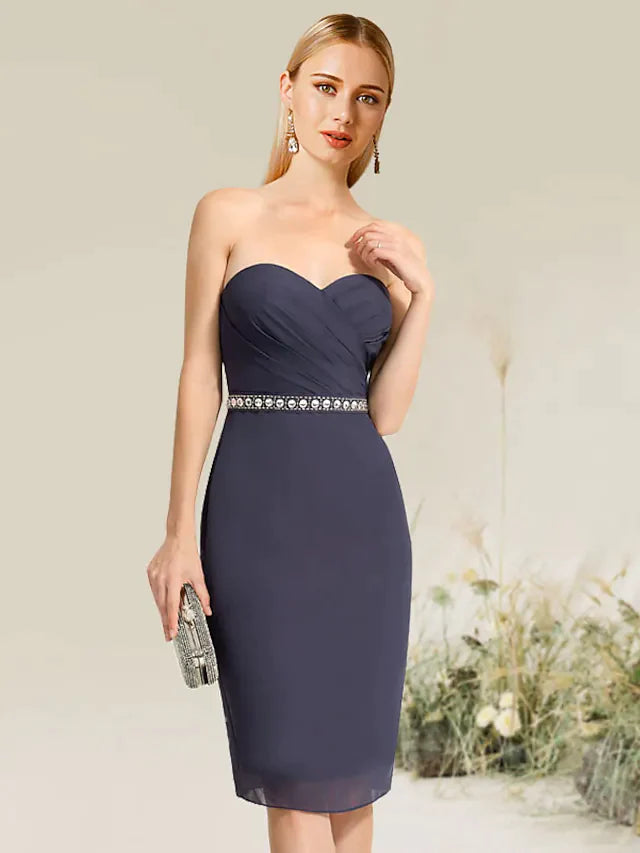Model posing in a versatile knee-length lace cocktail dress.