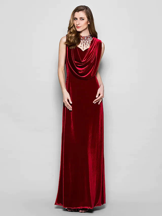 Woman in a dark velvet cowl neck floor length dress with crystal beading.