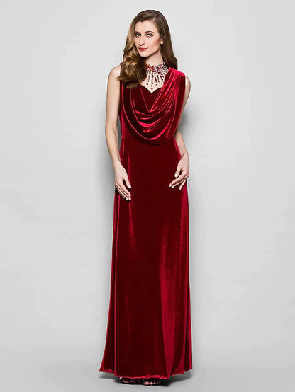 Woman in a dark velvet cowl neck floor length dress with crystal beading.