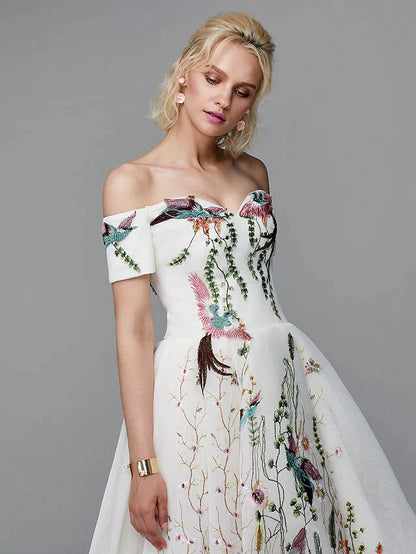 Close-up of floral embroidery and off-shoulder detail on the light blue ball gown.