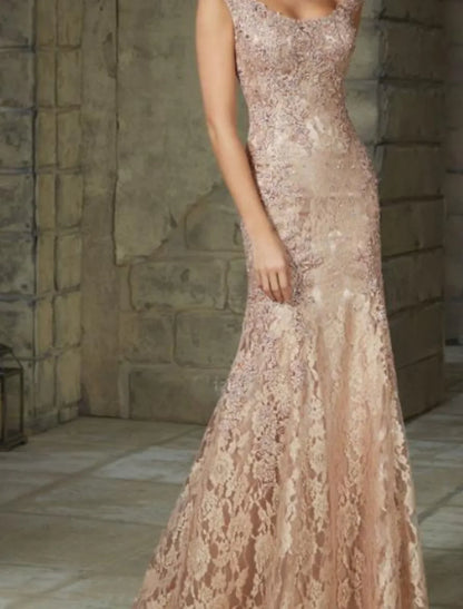 Back view of a woman in a floor-length floral lace mermaid trumpet gown.