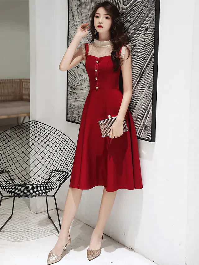 Woman wearing an elegant glittering A-line high neck sequin knee-length cocktail dress.