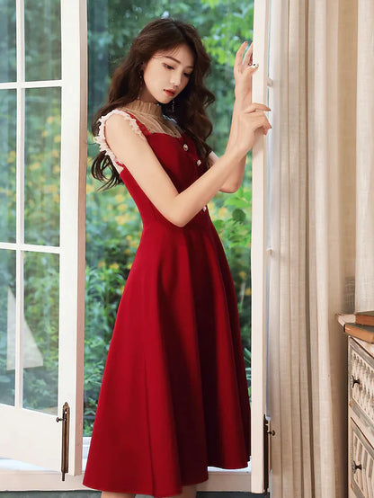 Back view of a woman in the glittering A-line high neck cocktail dress.