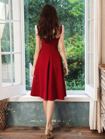 Woman in a high neck sequin dress, highlighting the knee-length silhouette.